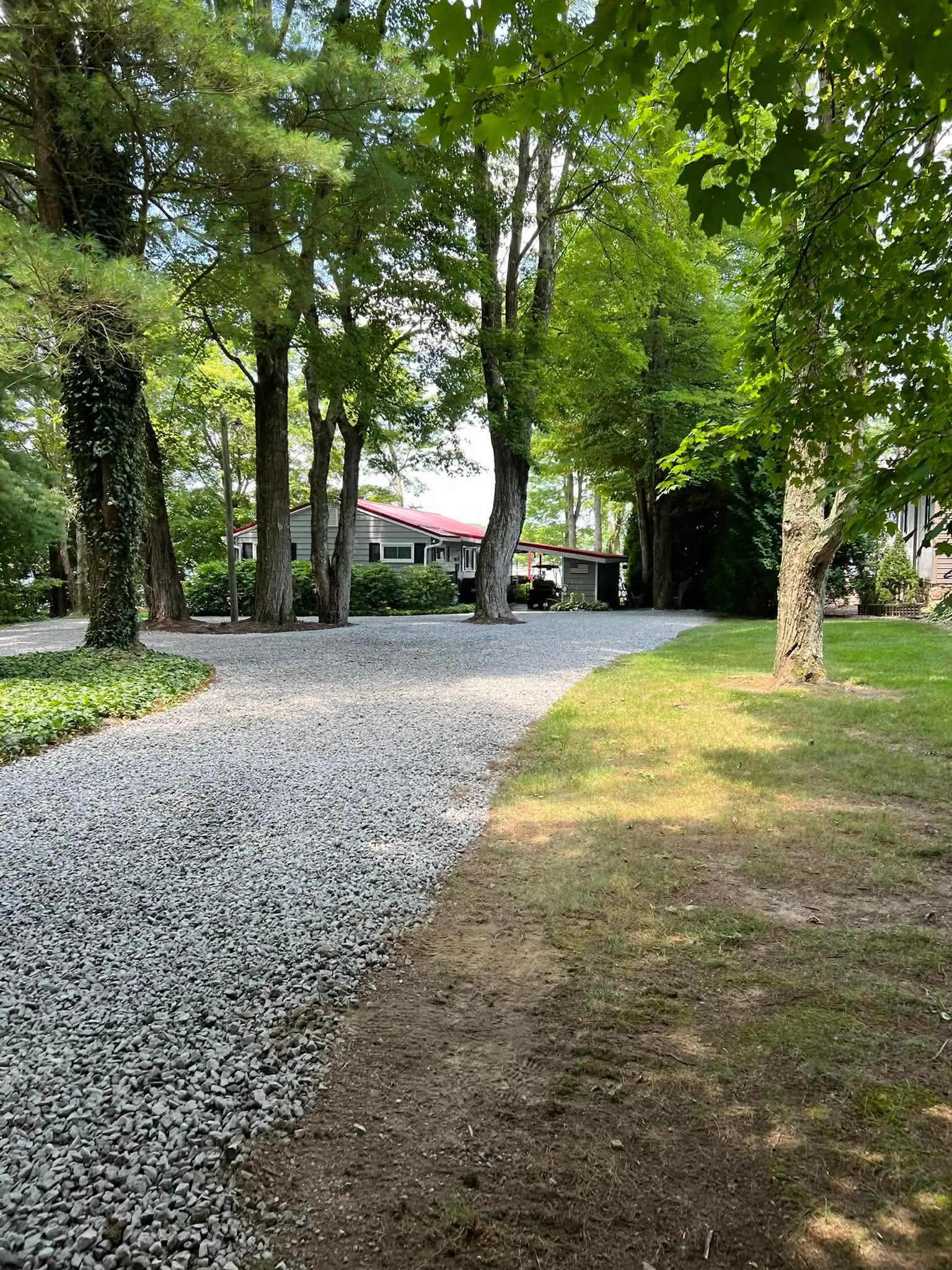 Freshly graded gravel driveway through a residential property by Poole Dirt Work