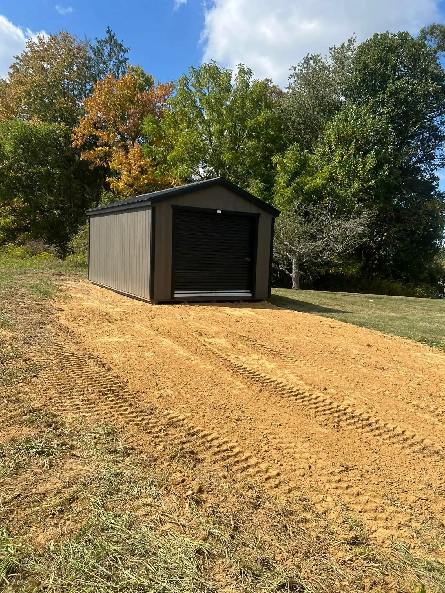 Newly graded site pad with shed installation by Poole Dirt Work